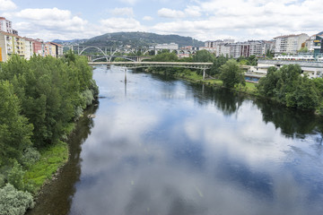 Fototapeta na wymiar Miño river passing through Orense Roman city located in Galicia. Spain