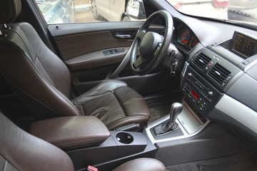 Driver's seat in the car with a brown interior