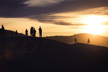 Fototapeta na wymiar People walking on sand dunes