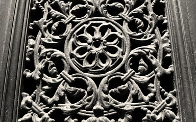 Very ancient wooden chiseled decoration with sepia effect, suitable to be used like background.