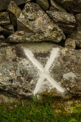 Cross on wall marking where wheel was found after explosion