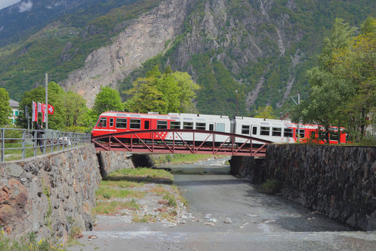 Train going along bridge through river Trient. Vernayaz, Martigny, Switzerland
