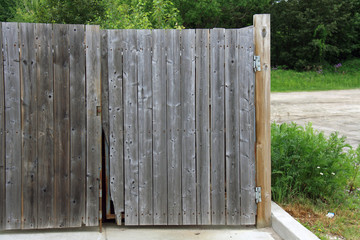 Aged fenced dumpster area