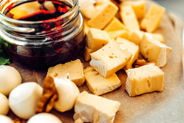 Cheese plate on a  table. Many kinds of cheese on a plate.