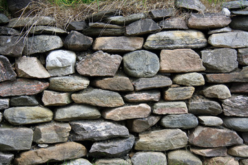 Fototapeta na wymiar Natural rock wall with grassy top