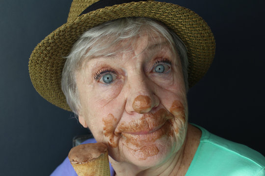 Happy senior woman eating ice cream