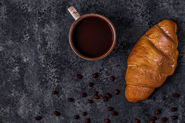 Fresh croissant on dark background.