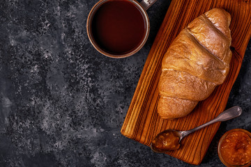 Fresh croissant on dark background.