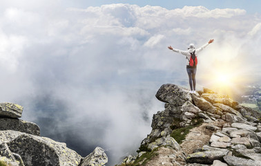 Obraz premium Tourist on the top of a mountain peak. Freedom - the concept.