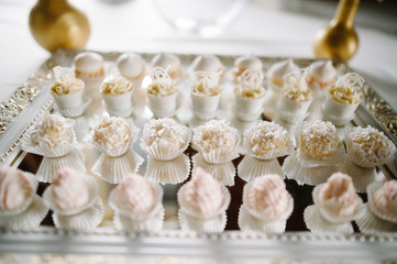Fototapeta na wymiar Tasty sweets cupcakes on a white background glass table