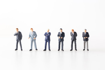 miniature model group of investor standing together isolated on white background.