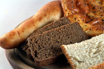 Mixed White Bread, Lavash, whtite and black bread on cutting pad 
