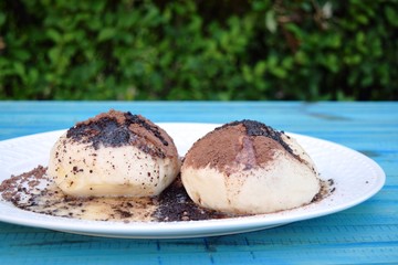Fresh homemade buns filled with strawberry jam .sprinkle with cocoa and sugar