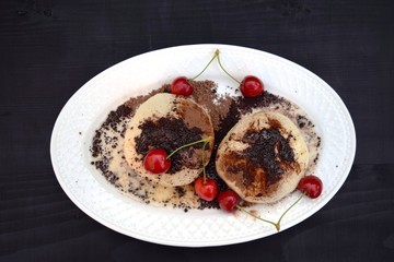 Fresh homemade buns filled with strawberry jam .sprinkle with cocoa and sugar