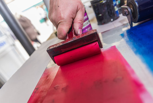 an acrylic paint roller for mono printing and screen printing, rolling paint ready for mono printing.