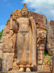 Fototapeta na wymiar Big Buddha statue carved out of rock. Sri Lanka, Anuradhapura