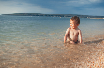 Fototapeta na wymiar A child sitting in the sea