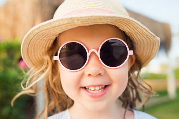 cute girl sunglasses hat closeup