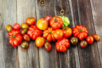 fresh red tomatoes on an old wooden tabletop