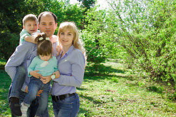 Fototapeta premium Portrait of a family of four outdoors.