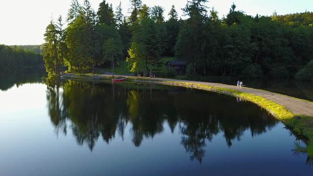 View of a lake in germany flying above with nice view on the trees. Ebnisee, slow camera move