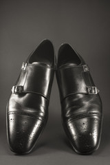 Beautiful black leather men's shoes. Fashionable shoes isolated on black background.