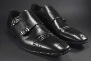 Beautiful black leather men's shoes. Fashionable shoes isolated on black background.