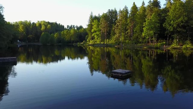 View of a lake in germany flying above with nice view on the trees. Ebnisee, slow camera move