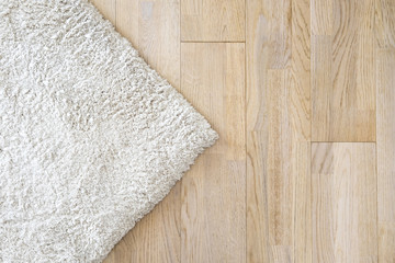 Laminate parquete floor. Light wooden texture. Beige soft carpet. Warm interior design - 159980714