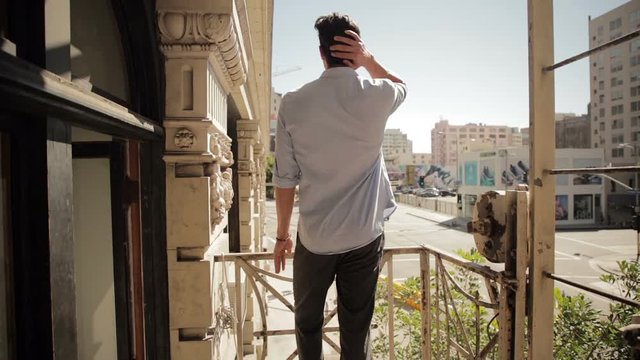 Man standing balcony 01