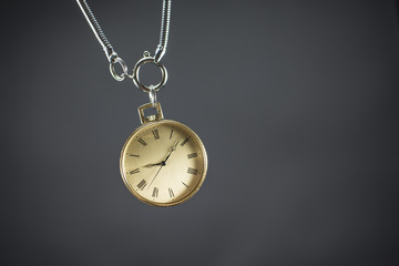 Close up of an old gold pocket watch. Beautiful antique watch isolated on black background.