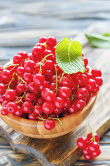 Bunches of red currant in a wooden bowl.