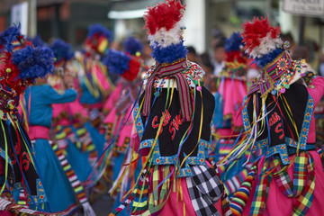 Tinkus dancing group in colourful costumes performing a traditional ritual dance as part of the Carnaval Andino con la Fuerza del Sol in Arica, Chile.