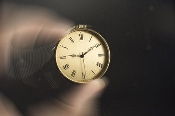 Close up of an old gold pocket watch. Beautiful antique watch. Man's hand holding a pocket watch.