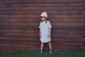 fashionable girl standing on wooden background