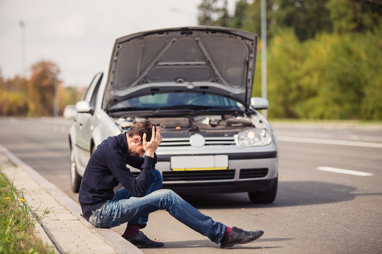 Man in despair because of the failure of his car