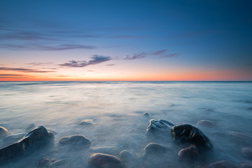 The pebbly beach in Poland at sunset, long exposure