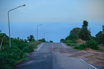 Countryside road with old big pole of light in  the evening,night,poorlight,dark,blue sky