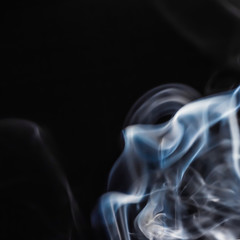Abstract figure of bluish smoke on a dark background. A collection of square backgrounds and textures.