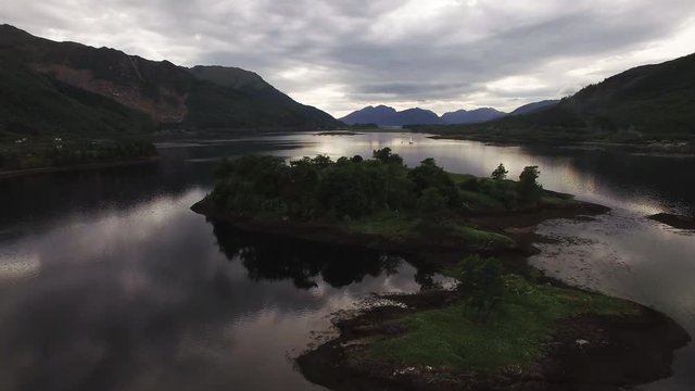 aerial footage flying over loch leven near glencoe in scotland during a cloudy evening
