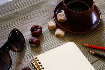 Open notebook and a cup of coffee