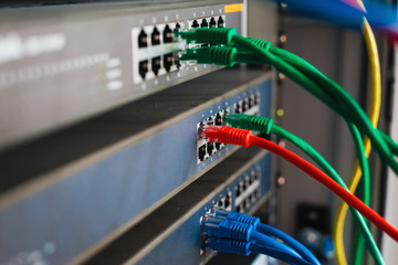 blue, red and green network cables connected to switch