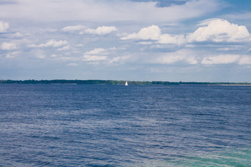 The Kiev Sea with a lonely sailboat and a cloudy sky