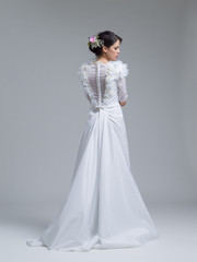 Fototapeta na wymiar Rear view of a beautiful young woman in a wedding dress