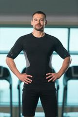 Handsome Personal Trainer Wearing Sportswear In Fitness Center