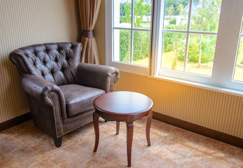 Brown leather sofa side window for sit read a book,relax time,bright sunlight