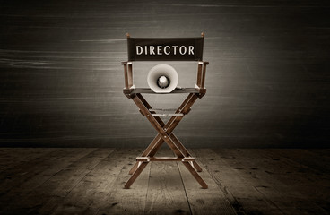 Director chair and megaphone, scene in dark room