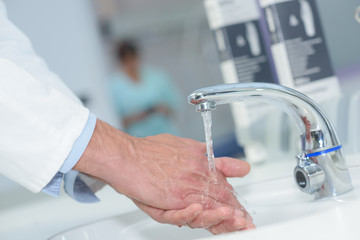 doctor handwashing in a hospital sink