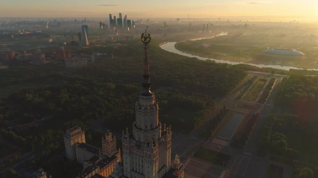 Flying over moscow state university and moscow river in the sunny morning. City in sunrise fog. Aerial view.
