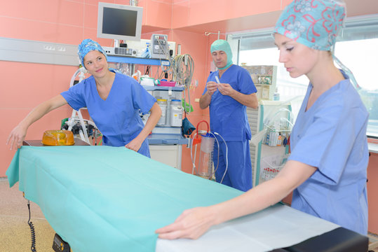 Nurses Making A Bed In A Hospital